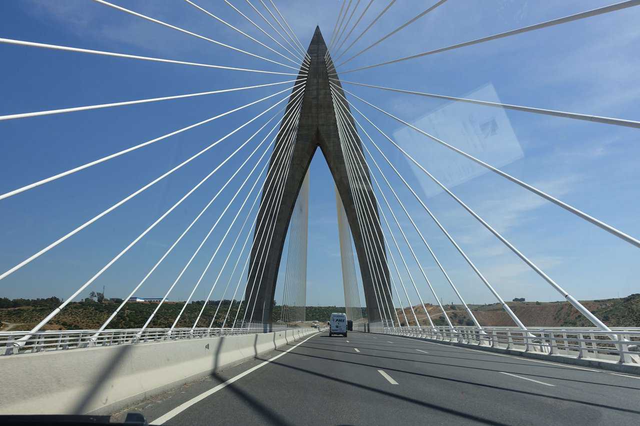 Driving across the architectural Mohammed VI Bridge with cables converging overhead.