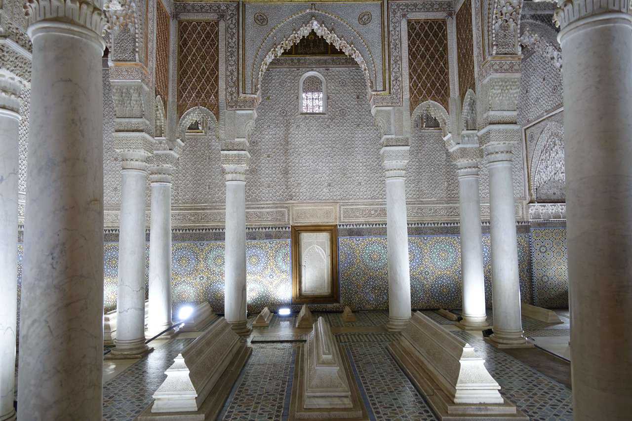 Ornate interior of the Saadian Tombs in Marrakech featuring marble columns and intricately tiled walls.
