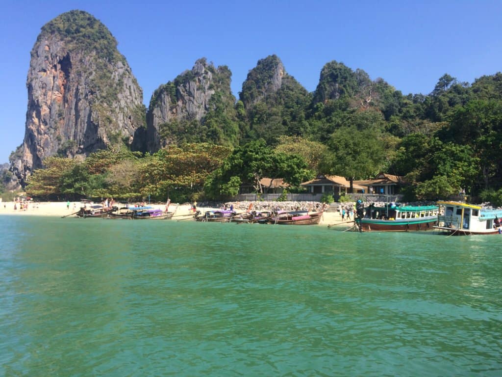 Green water with boats and white sand 