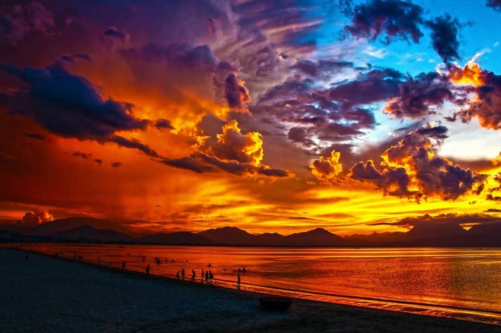 An orange and red sky over a beach 