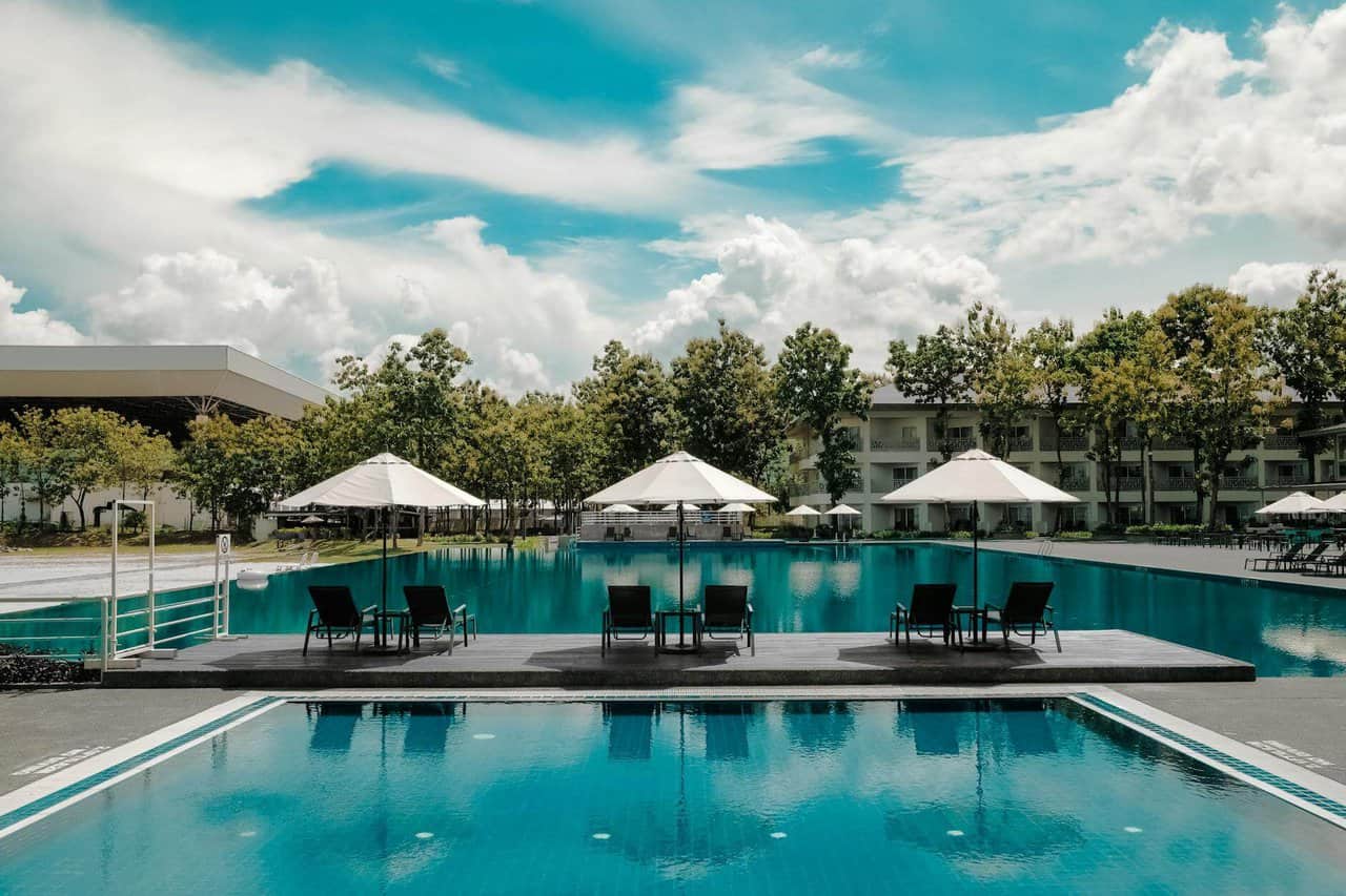 swimming pool under white cloudy blue sky at one of the luxury resorts Australia