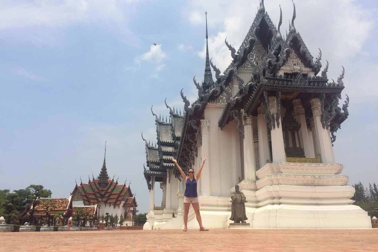 woman standing in front of a white temple in the ancient city