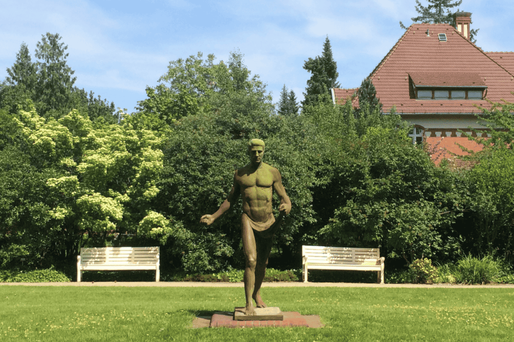 green moss covered statue in a botanical garden