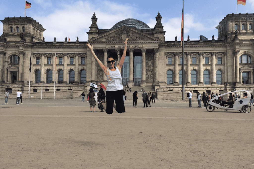 woman jumping in front of a german building