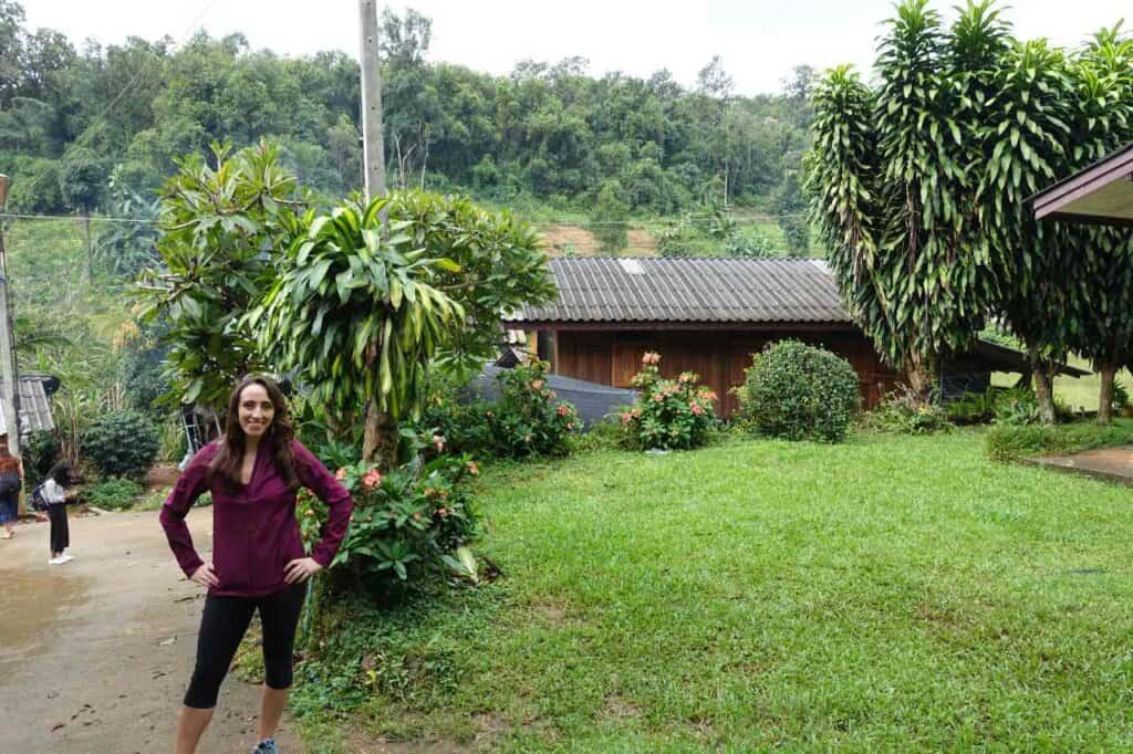 woman standing in a lush green farm in thailand during her thailand travel itinerary 