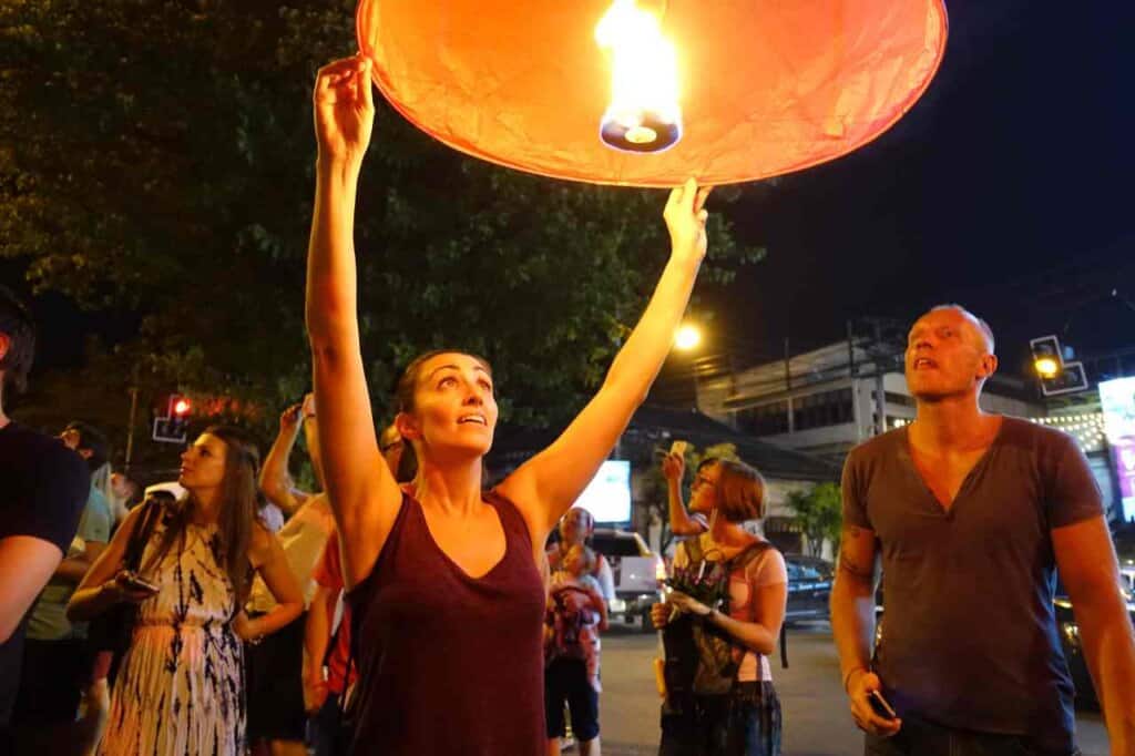 woman holding an orange lantern 