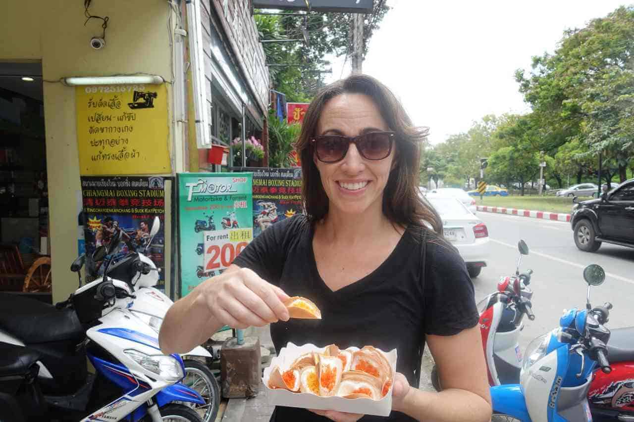 woman holding a thai dessert snack in a place to travel in thailand