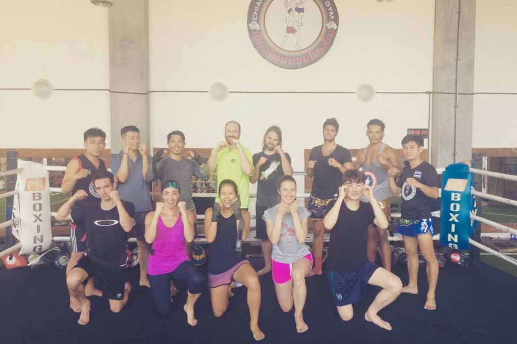 Group of people holding up their fists at muay thai gym in chiang mai
