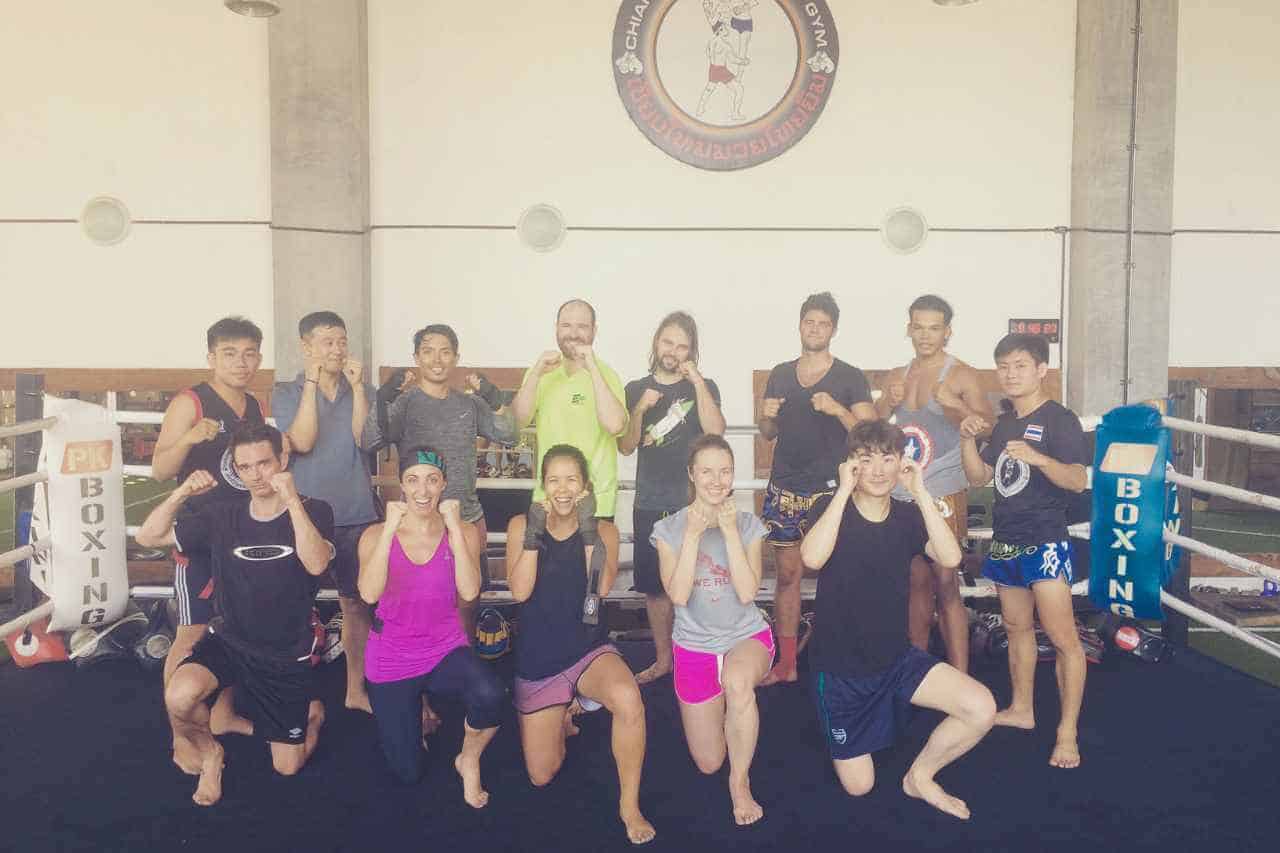 Group of people holding up their fists at muay thai gym in chiang mai