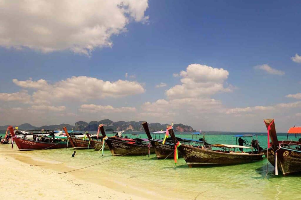 group of long tail boasts in thailand as one of the best hot countries to visit in April 