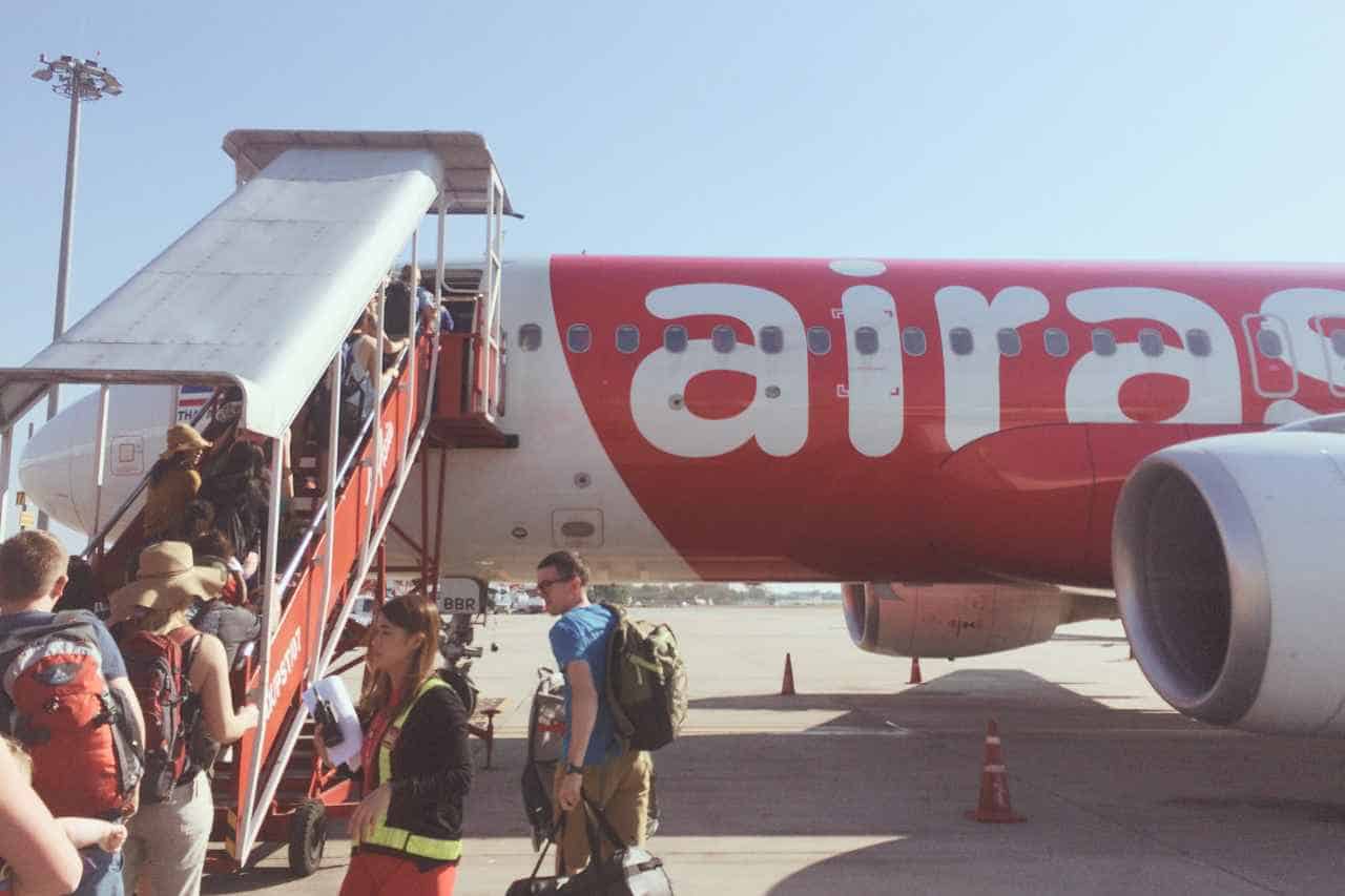 white airplane with a red airasia sign