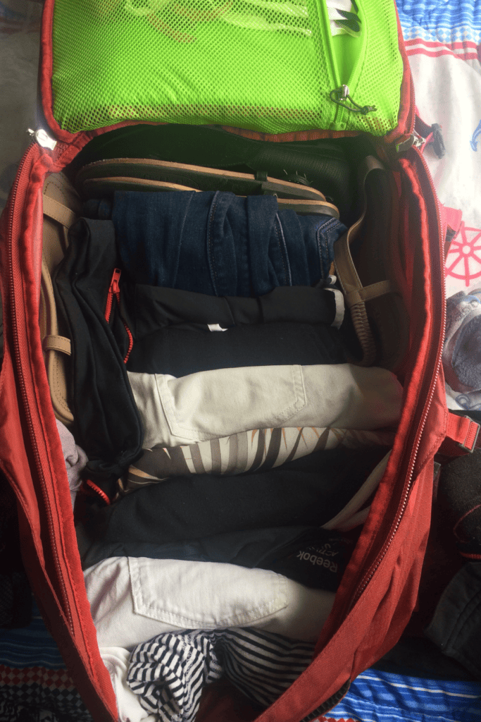 inside of a red ladies backpack for travel