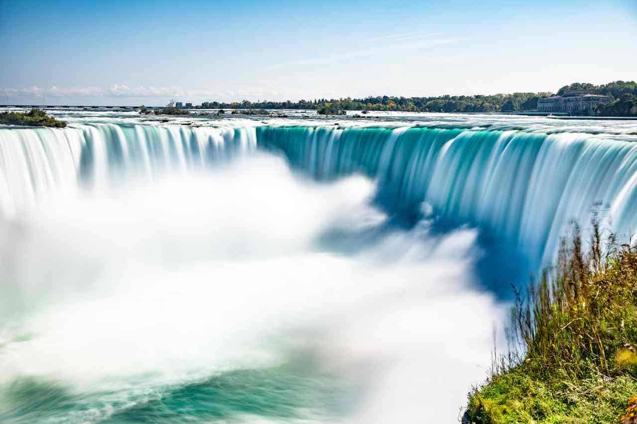 Niagara Falls straddling USA and Canada, with millions of gallons plunging over