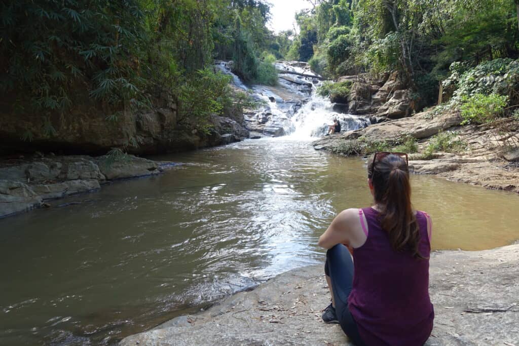 woman sitting and looking at chiang mai waterfalls