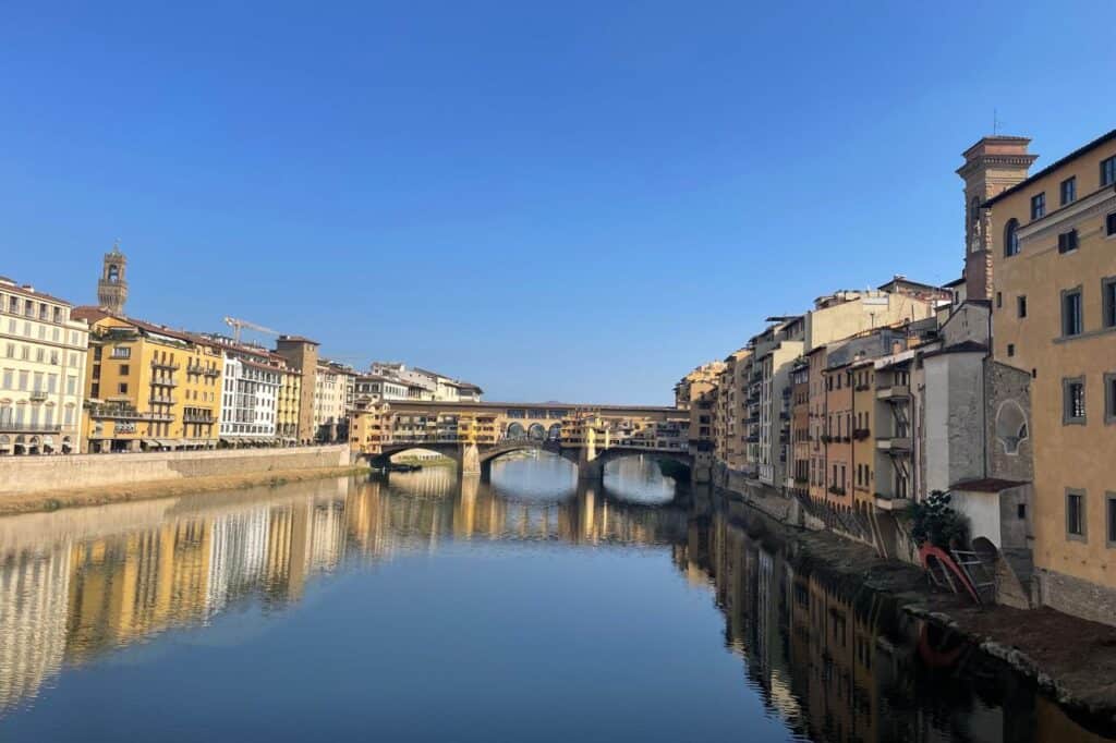 view of the ponte vecchio bridge from far away in florence italy