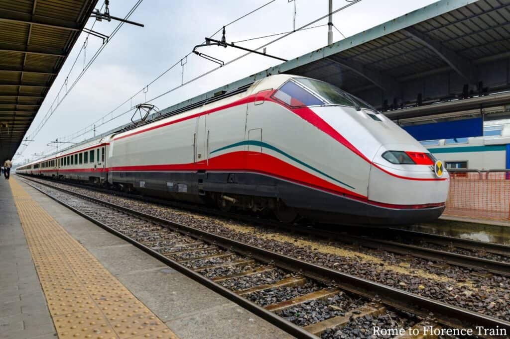 a grey and red train traveling from florence italy to venice italy