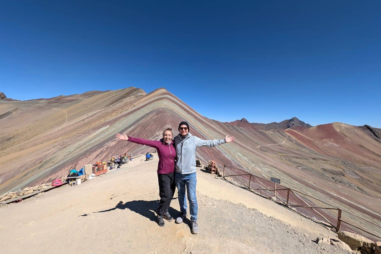 two people in front of rainbow mountain in peru