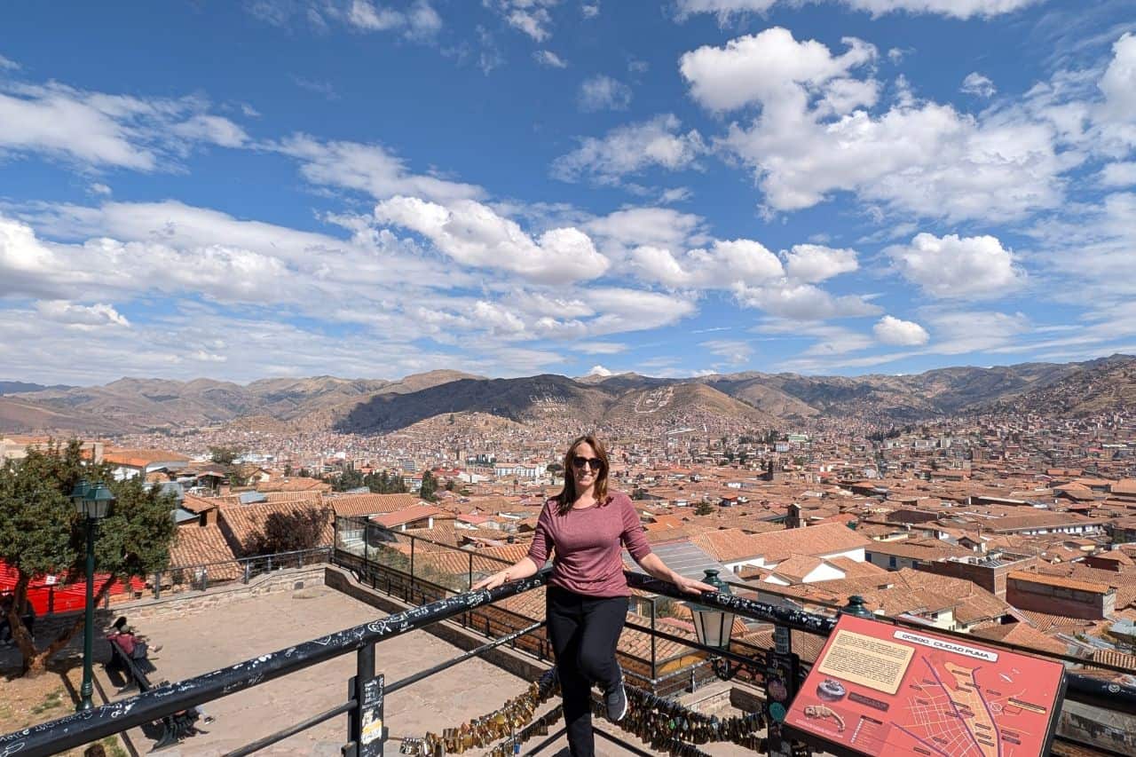 woman overlooking the orange rooftops in Cusco