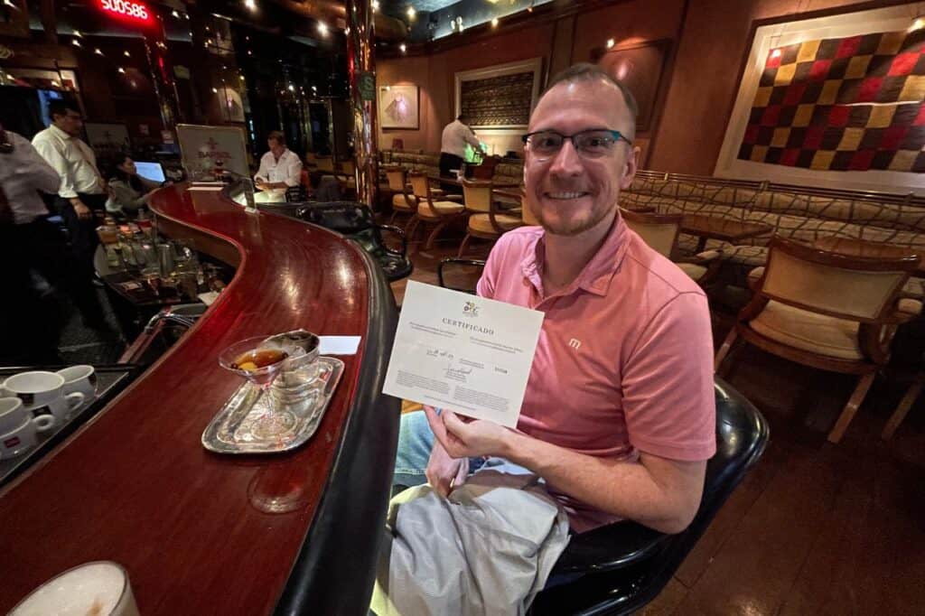 A man holding a certificate from Ole Restaurant in Lima