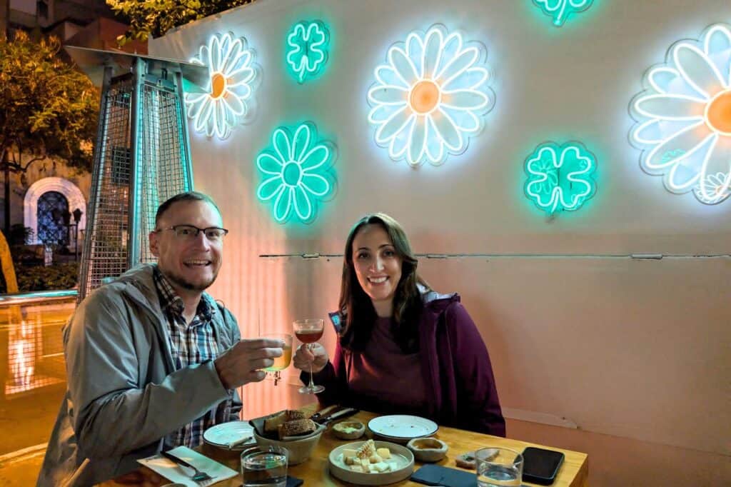 A couple enjoying a cocktails and a cheese plate – things to do in Lima.