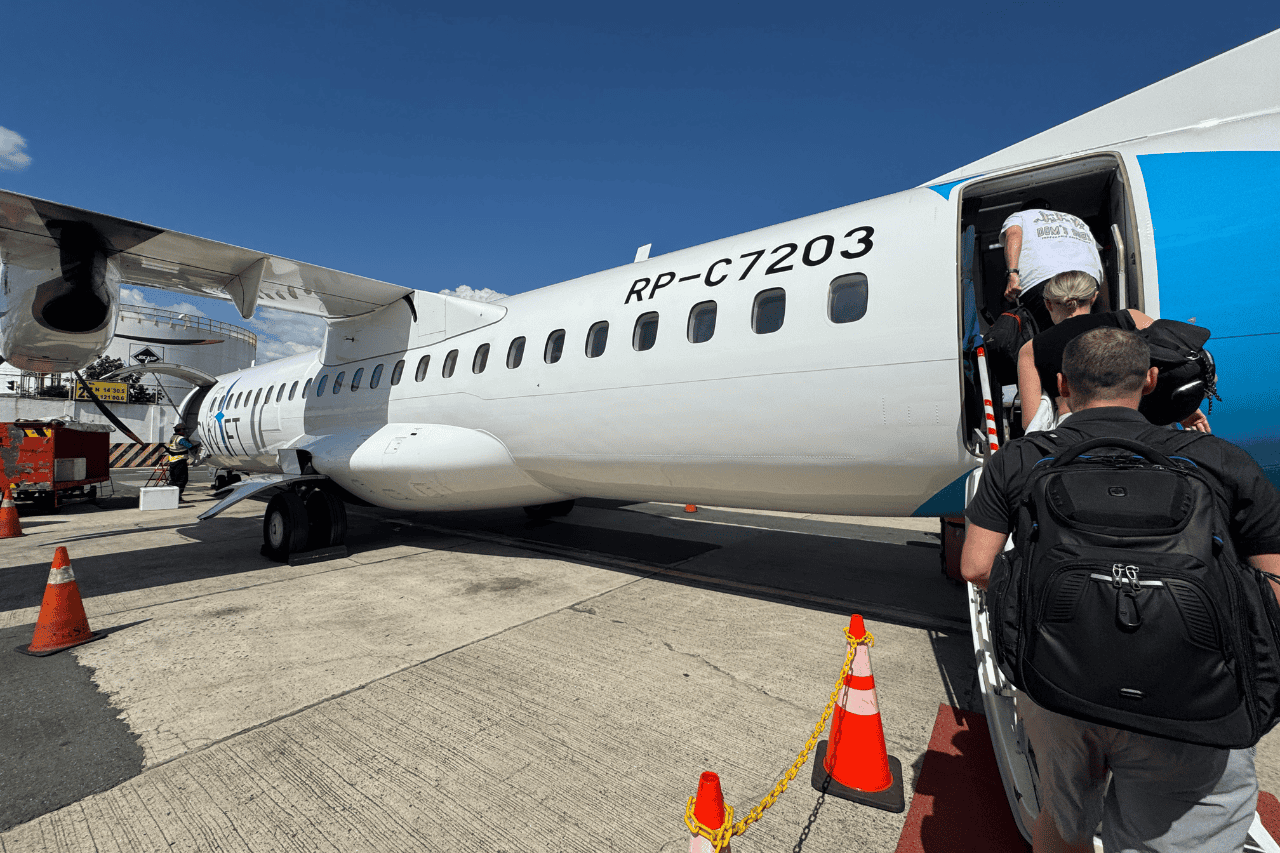 People entering an AirSwift airplane at the airport at El Nido