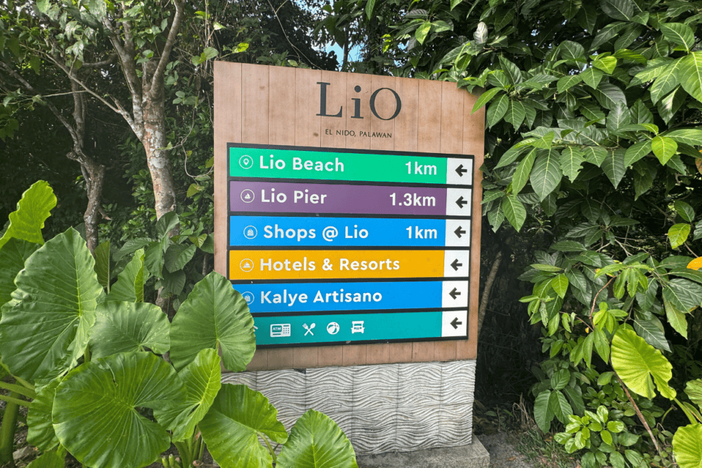 A colorful directional sign outside of Lio Airport