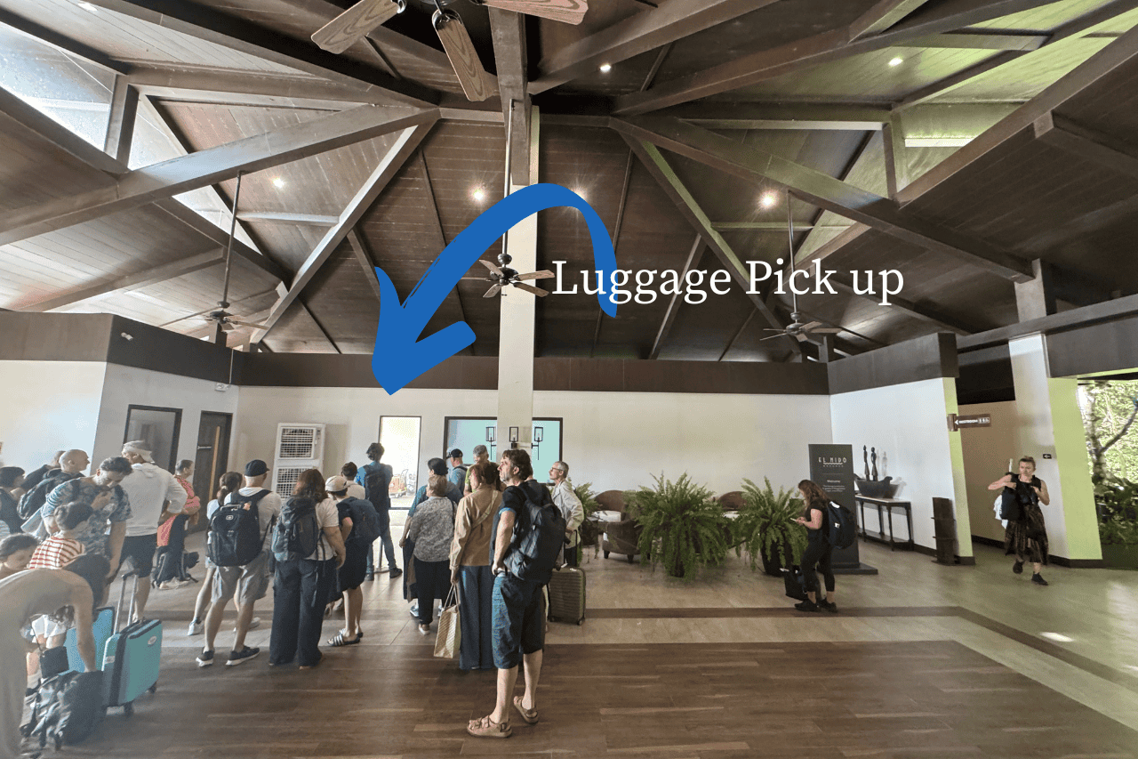 The interior of the airport in El Nido with an arrow pointing to the door where you pick up luggage