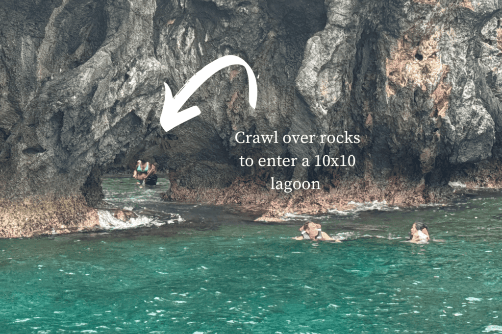 People entering the small lagoon over rocks