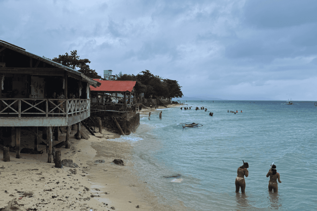 Small Rocky Beach in Moalboal with two people snorkeling