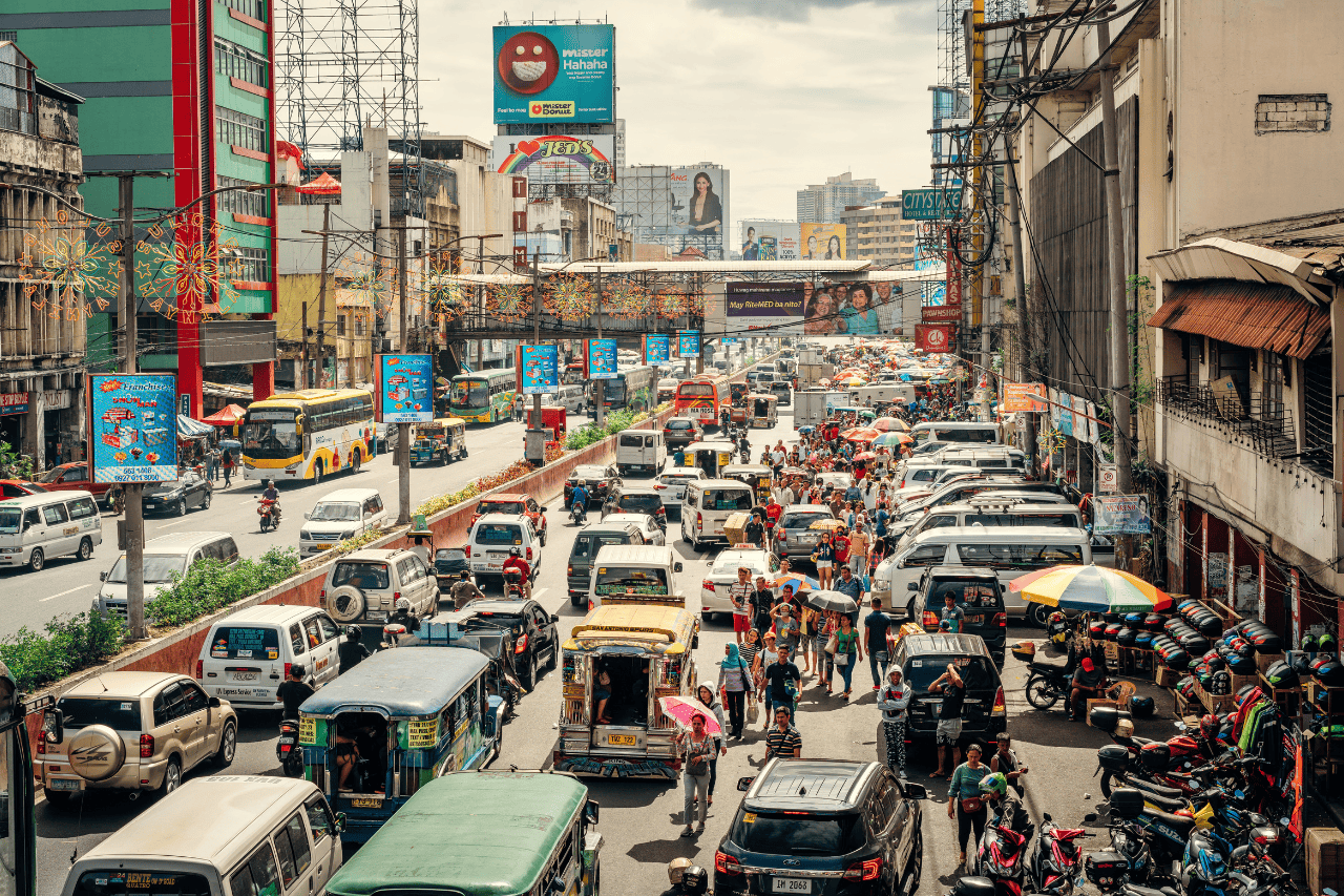 Crowded street full of cars, scooters and buses in Manila