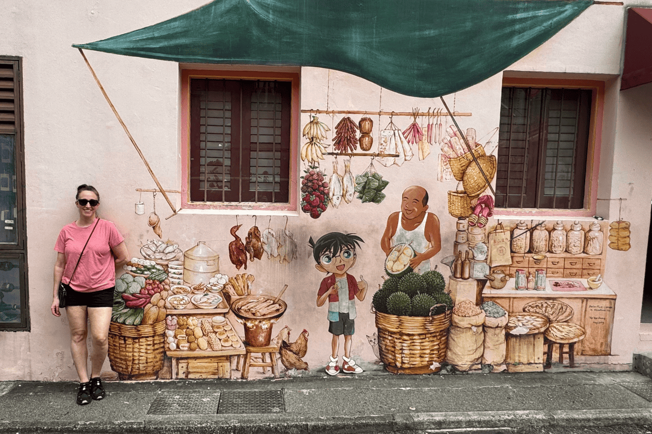 Chinatown’s vibrant street mural with a woman standing in front of it