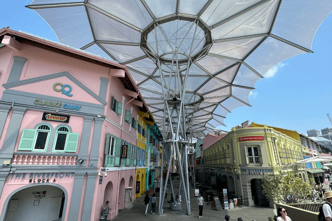 Colorful riverside nightlife scene at Clarke Quay with vibrant restaurants and bars