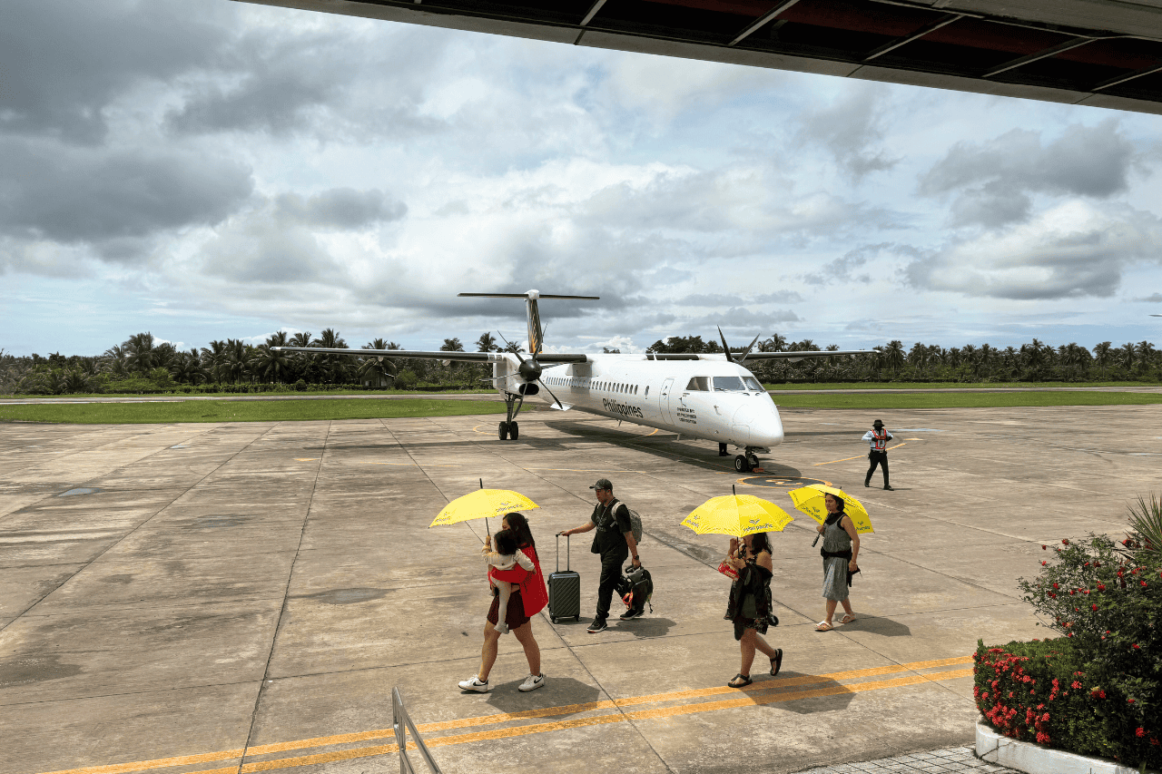 Passengers walking on the tarmac at Siargao Airport after landing