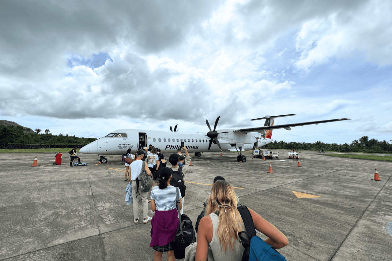 Passengers boarding a plane directly from the tarmac at Siargao Airport