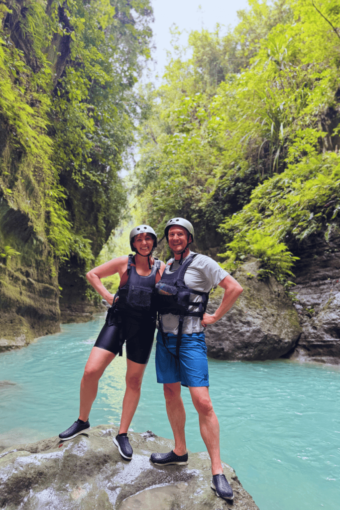 Two people standing on a rock during canyoneering in the Phillipines