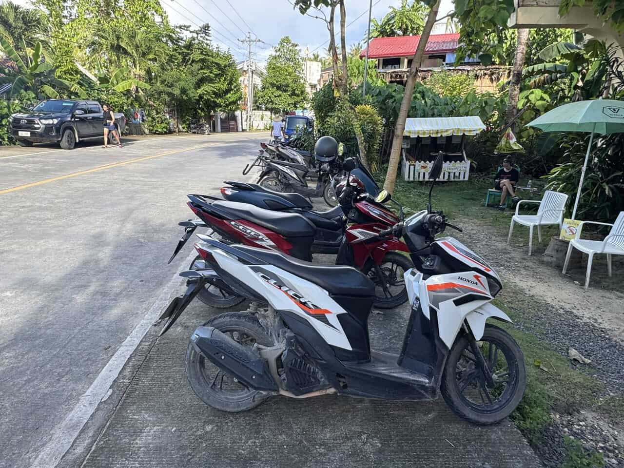 parked scooters on the side of the road in the Philippines