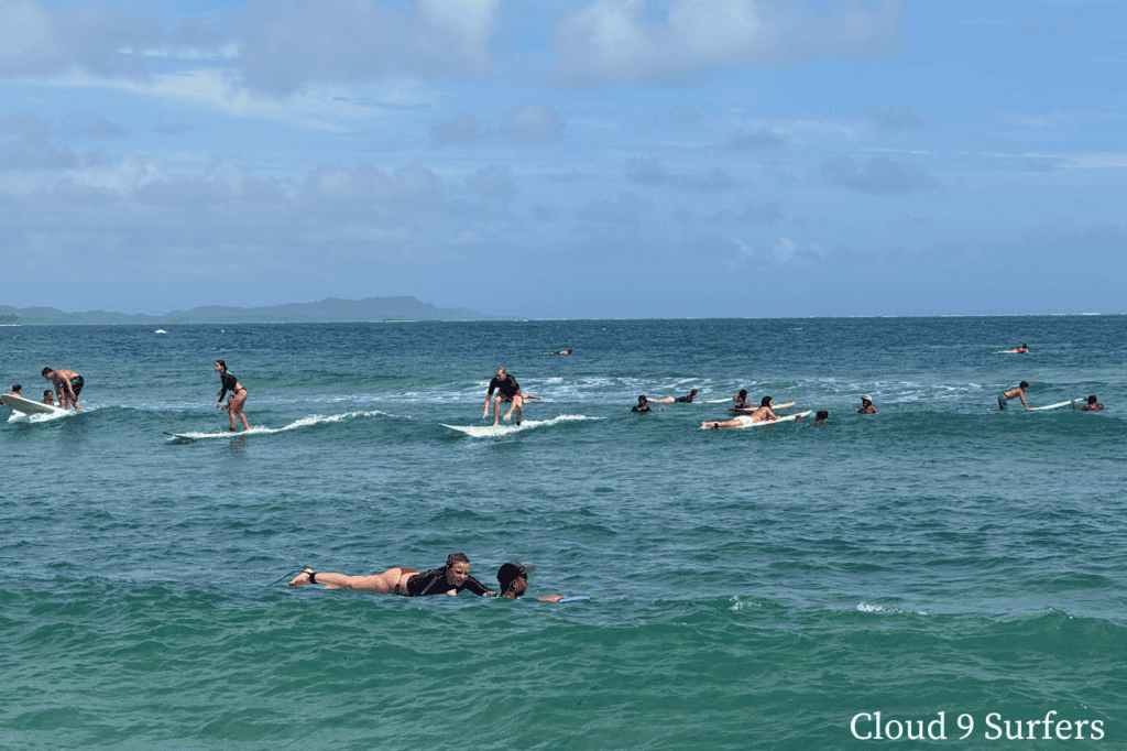 Surfers riding a wave at Cloud 9 in Siargao