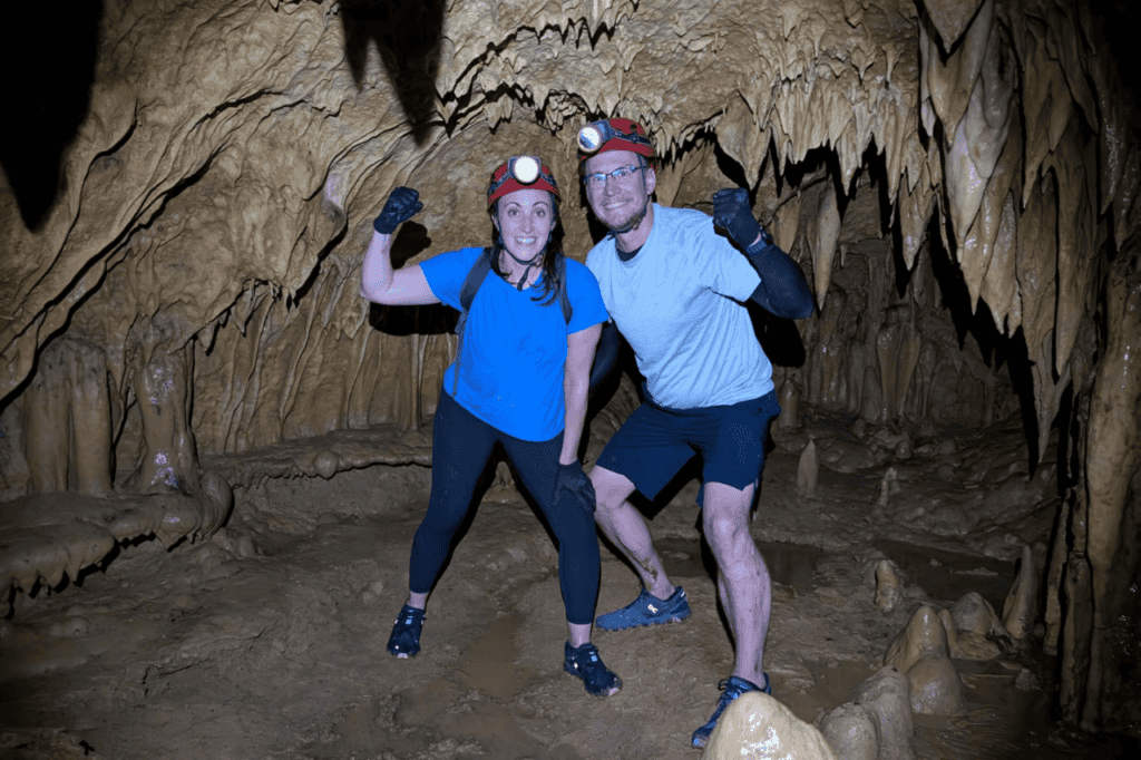 Tourists exploring Marvelos Somoyot Cave with headlamps and guides