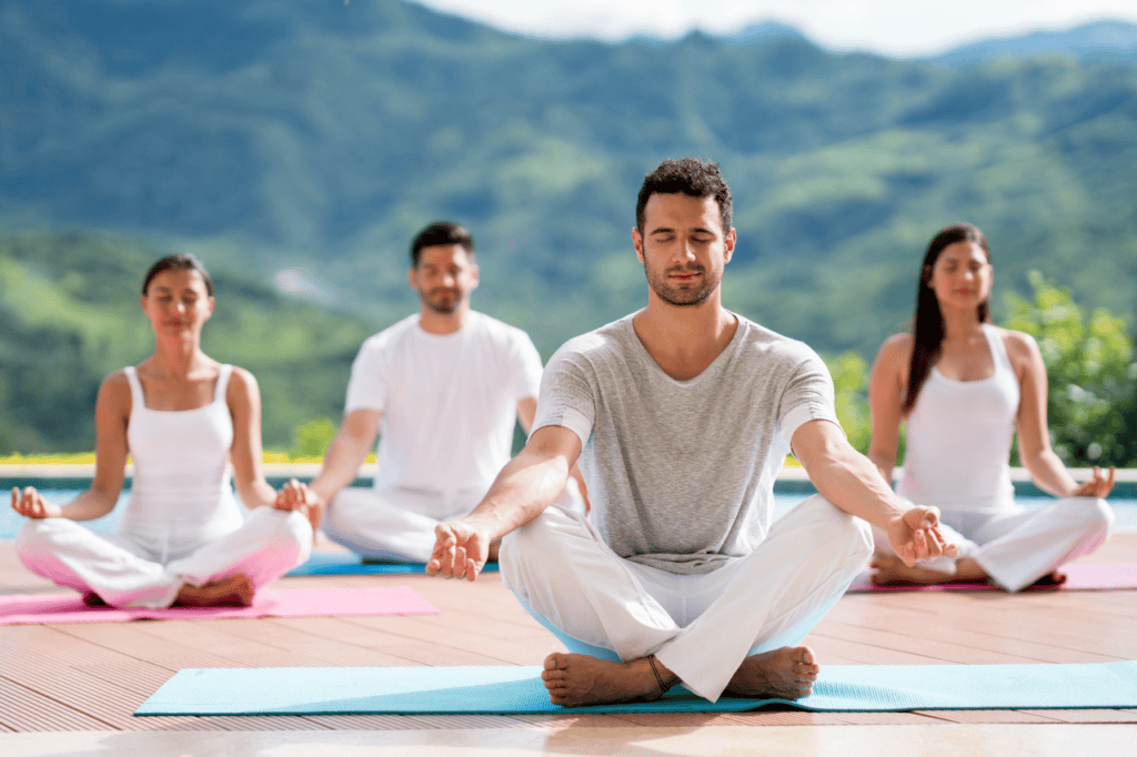 Group of men and woman meditating during a bali yoga retreat