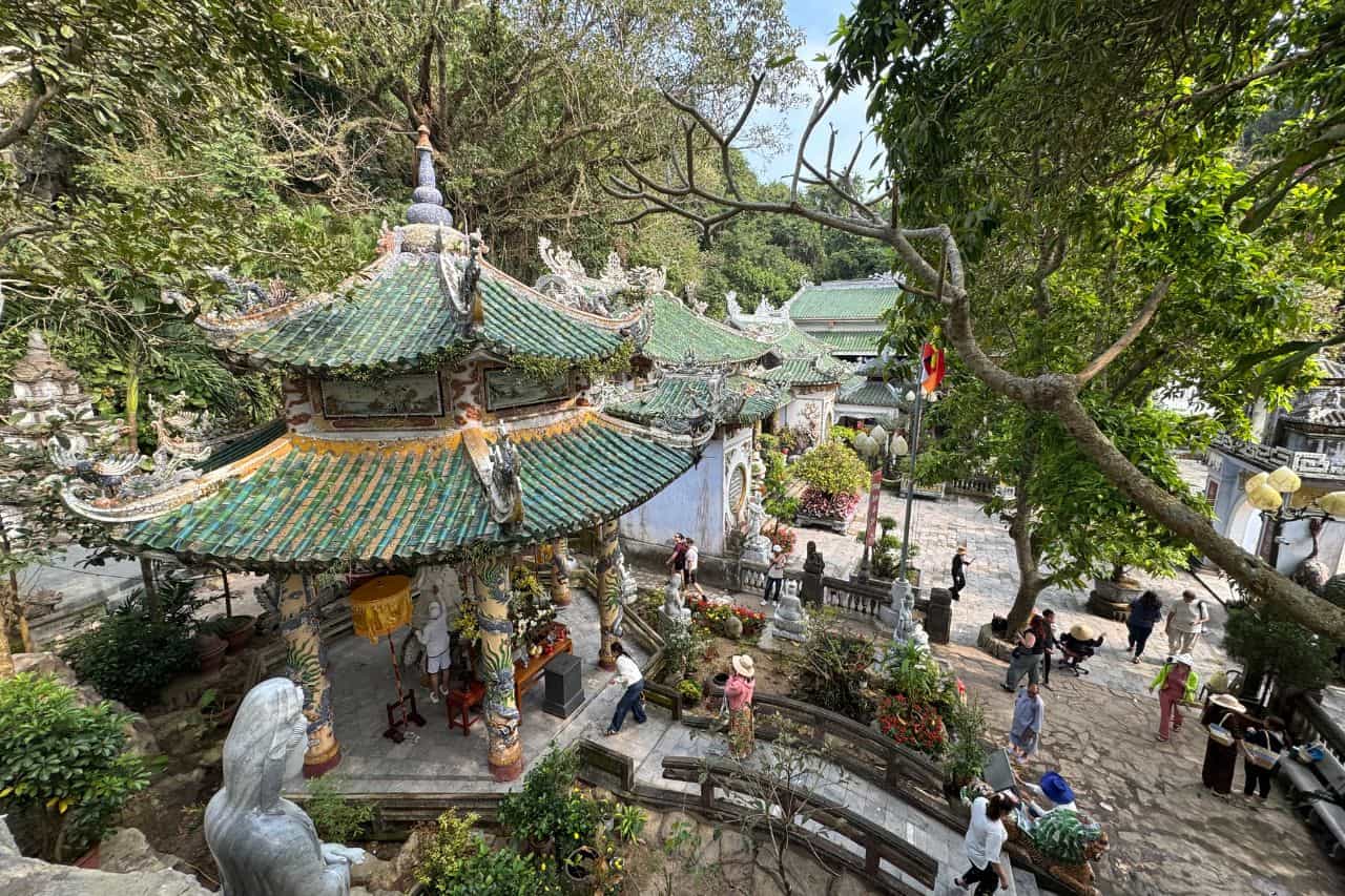Ornate pagoda and temple courtyard surrounded by lush greenery at Marble Mountains Vietnam