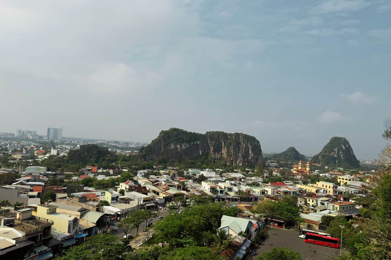 Panoramic cityscape with Marble Mountains rising amid urban surroundings in Da Nang, Vietnam