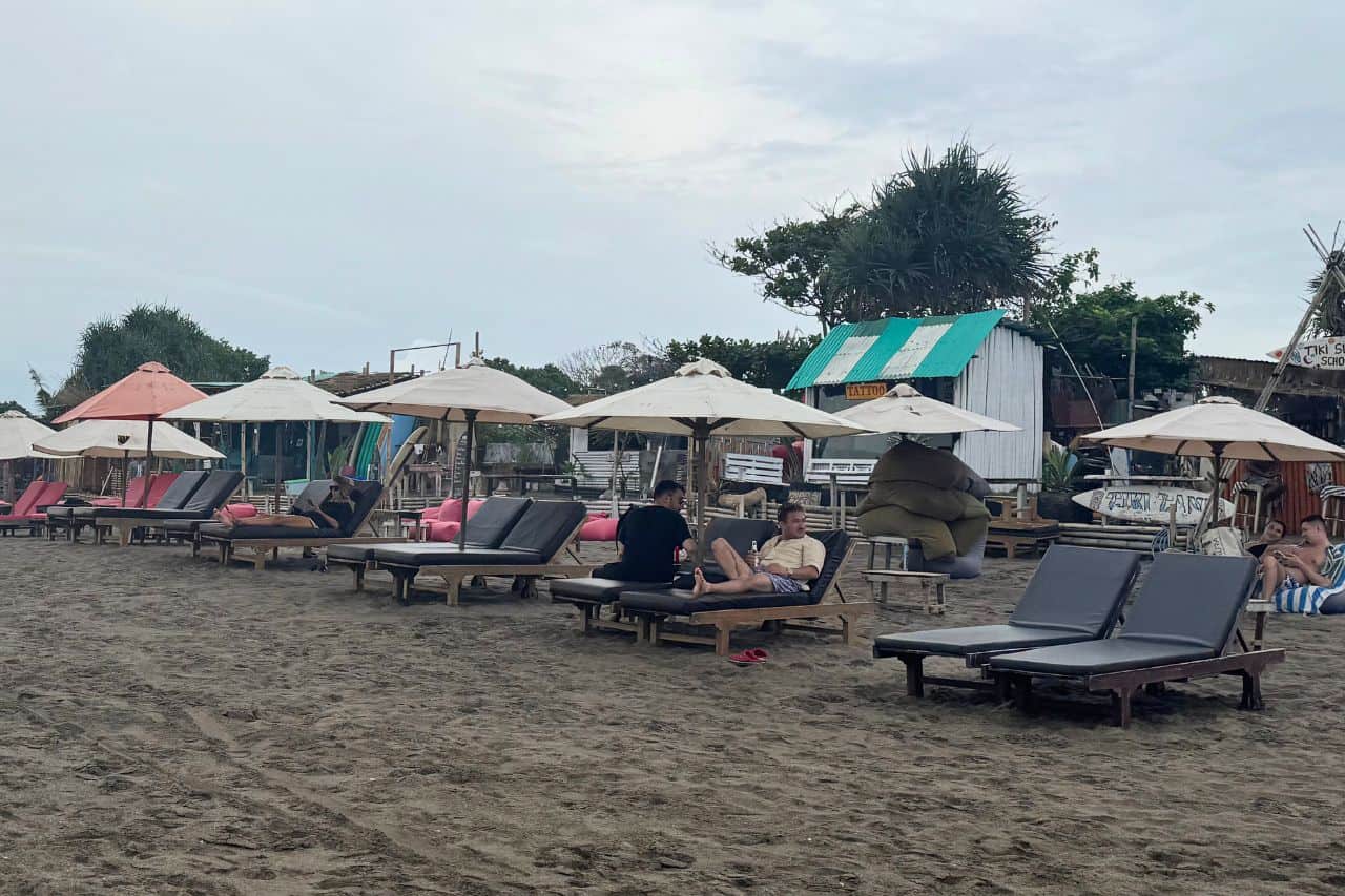 People are relaxing on the beach with umbrellas