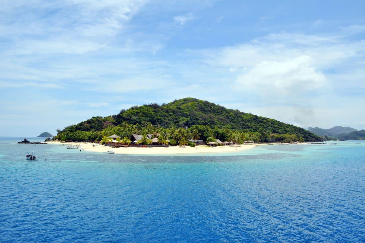 Tropical island in the Gili Islands surrounded by turquoise waters and sandy beaches.