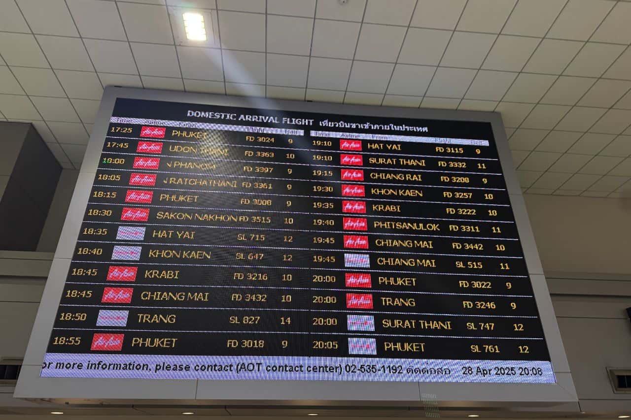 Digital flight board showing domestic arrivals at the airport in Krabi, Thailand, featuring destinations like Phuket and Chiang Mai