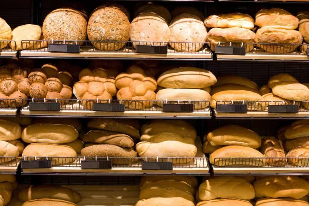 Assortment of fresh bread loaves on bakery shelves, reflecting the authentic Italian baking traditions found in Little Italy NYC