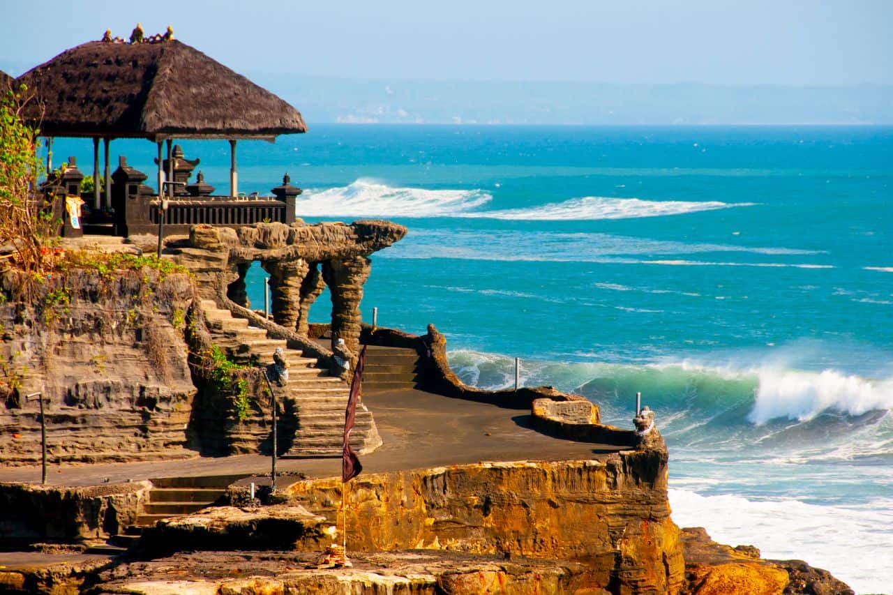 Tanah Lot Temple near Canggu Bali with ocean waves in the background, popular for sunset views and one of the only attractions in Canggu