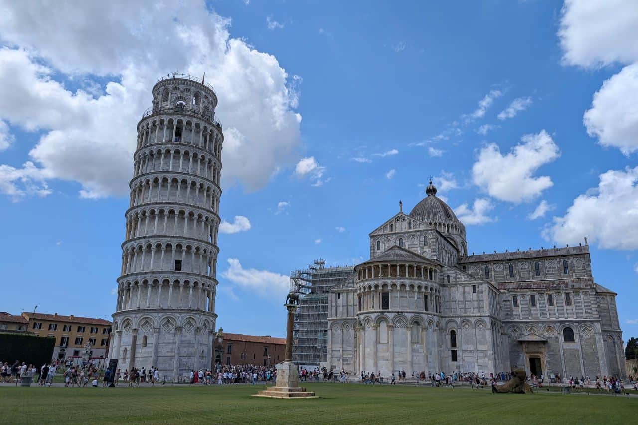 Leaning Tower and Cathedral of Pisa on a Sunny Day Bright, clear view of the Leaning Tower of Pisa and Pisa Cathedral under a blue sky in Piazza dei Miracoli