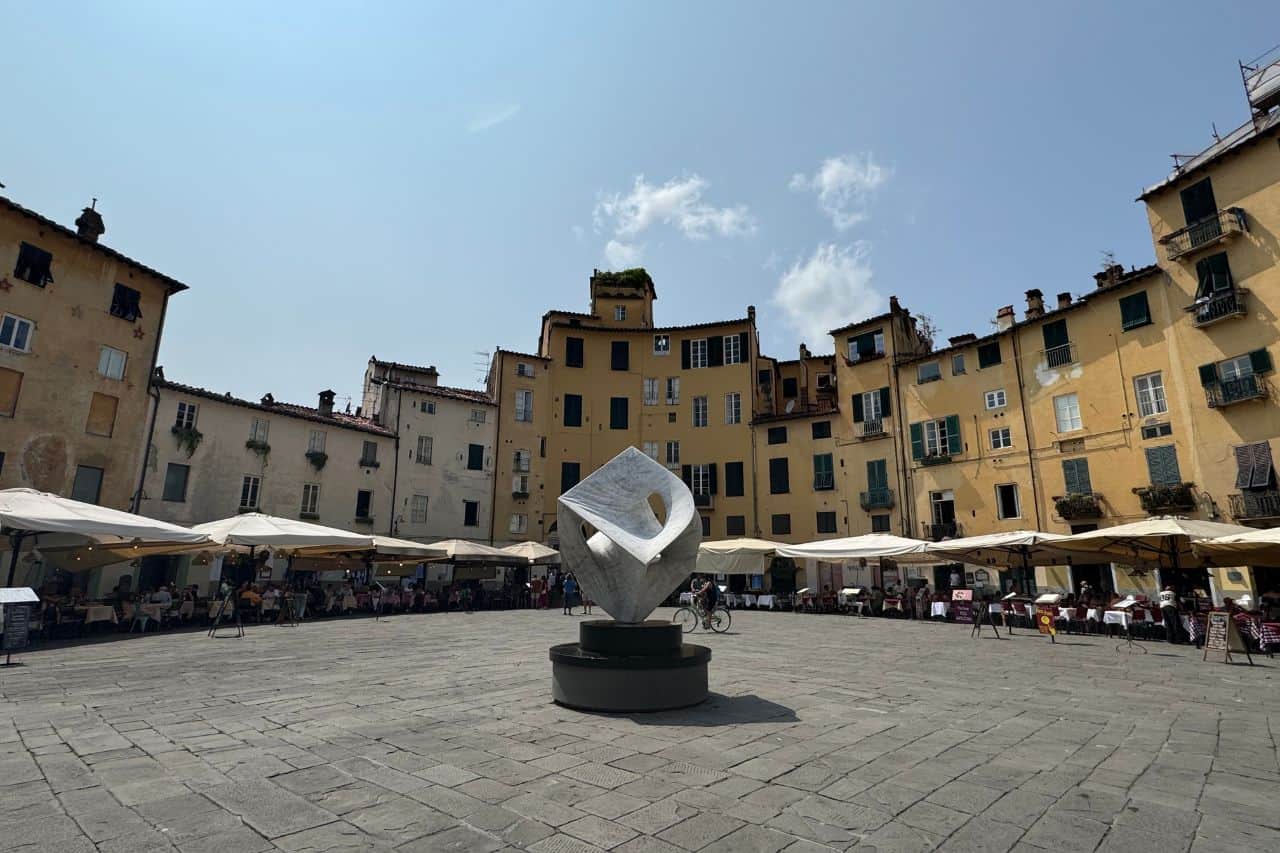 The Round Amphitheater Surrounded by Yellow Buildings in Lucca The ancient Roman amphitheater in Lucca Italy, surrounded by charming yellow buildings