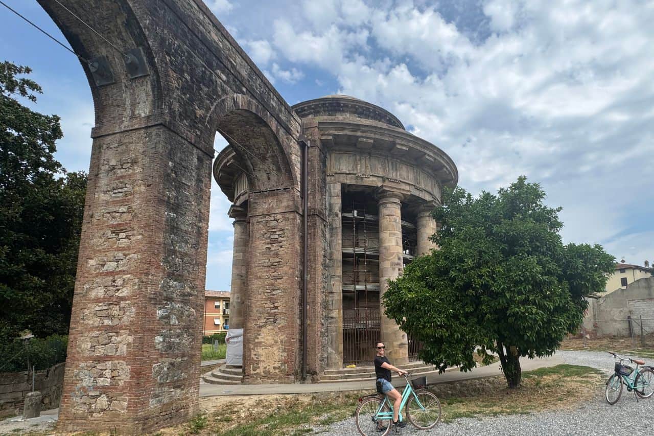 nottolini-aqueduct Woman riding a bike in front of the Nottolini Acqueduct in Lucca Italy