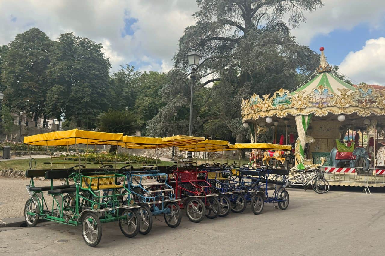 Pedal Carts Available for Rent in Lucca Italy Colorful pedal carts lined up for rent on the streets of Lucca Italy, perfect for group rides around the city walls
